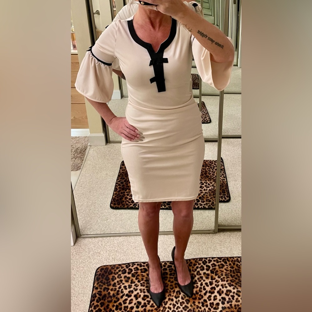Cream dress with black ties. Size Medium
